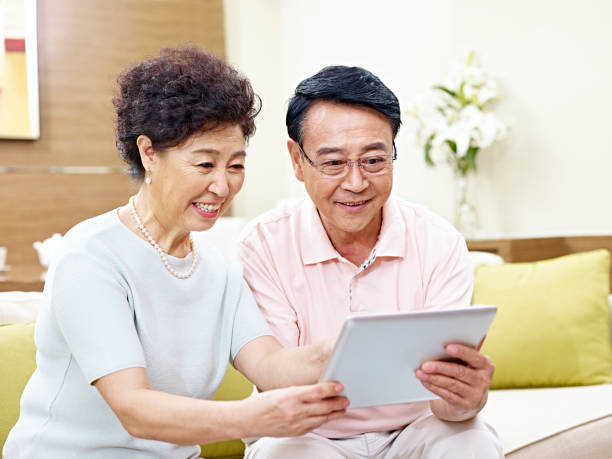 istock happy senior asian couple using tablet together 663845214
