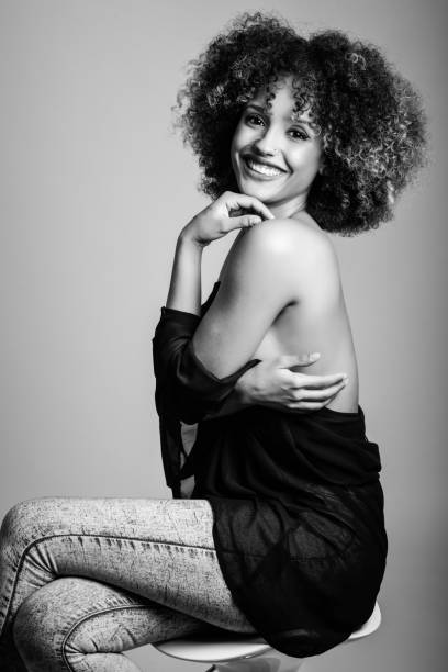 istock Young black woman with afro hairstyle smiling 663850000