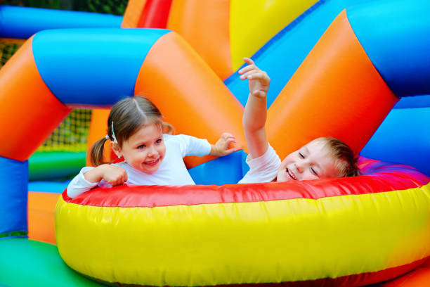 istock excited kids having fun on inflatable attraction playground 663852270