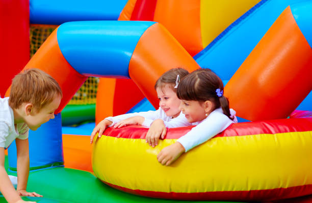 istock excited kids having fun on inflatable attraction playground 663852310