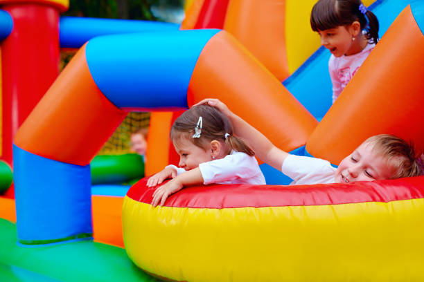 istock excited kids having fun on inflatable attraction playground 663853132
