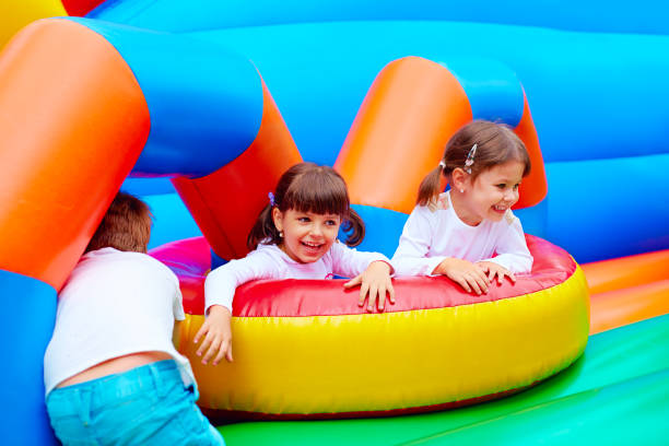 istock excited kids having fun on inflatable attraction playground 663853168
