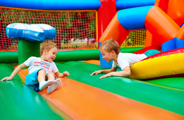 istock happy kids having fun on inflatable attraction playground 663853202