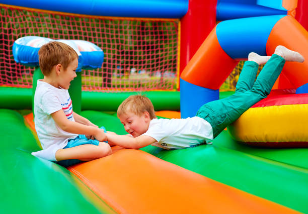 excited kids having fun on inflatable attraction playground