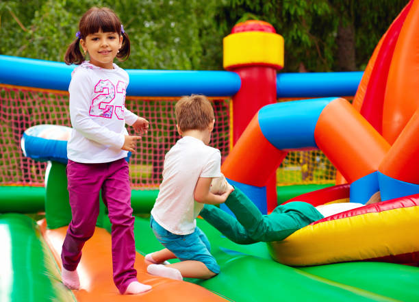 istock happy kids having fun on inflatable attraction playground 663856806