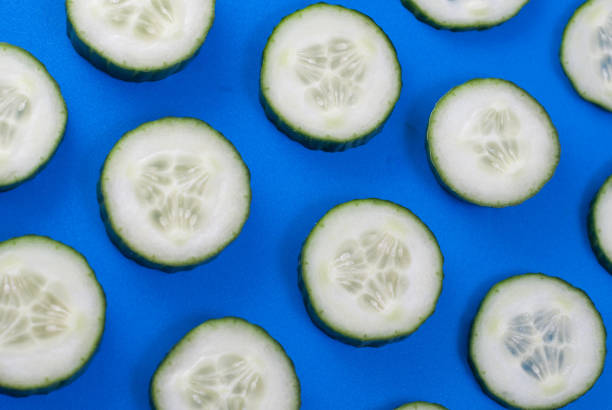 istock The pattern of cucumber on blue background, 663861954