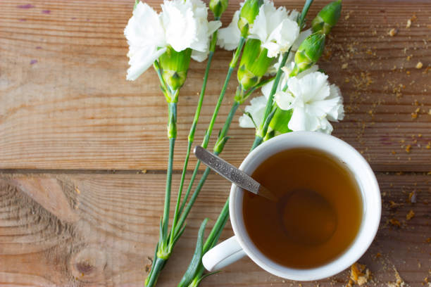 istock cup of tea and white flowers 663864110