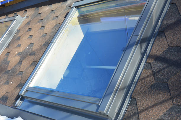 istock Roof windows and skylights installation with snow in winter. 663864494