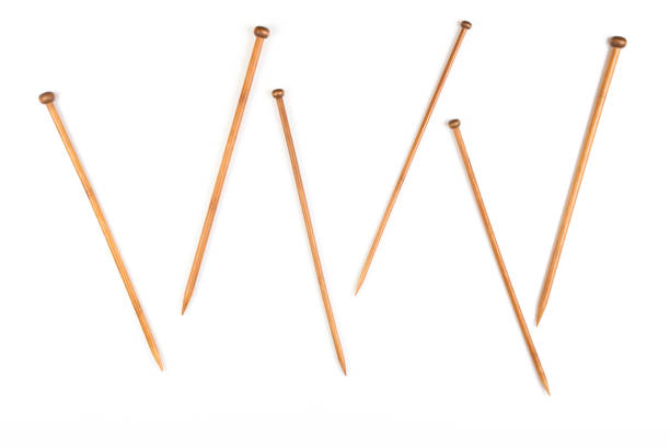 istock Variety of bamboo knitting needles in different sizes on white background 663867144
