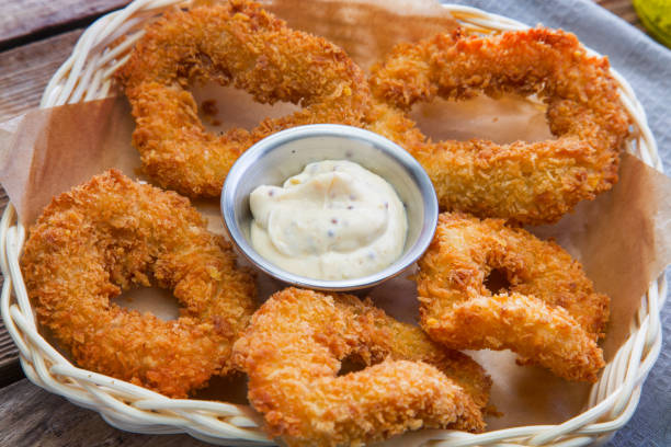 istock Squid rings in batter with white sauce 663873420