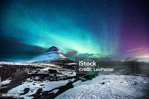 istock Northern lights in Mount Kirkjufell Iceland with a man passing by 663874486