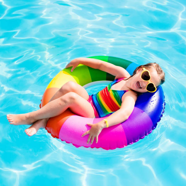 istock Child with toy ring in swimming pool 663877082