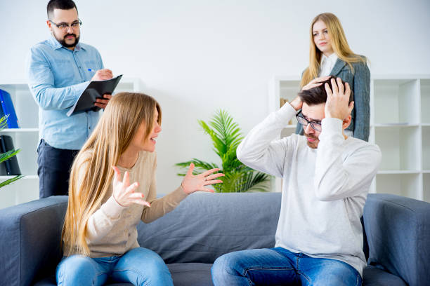 istock Couple arguing at therapy session in therapists office 663878850