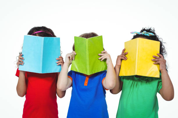 istock Three kids standing with books in front of their faces 663891456