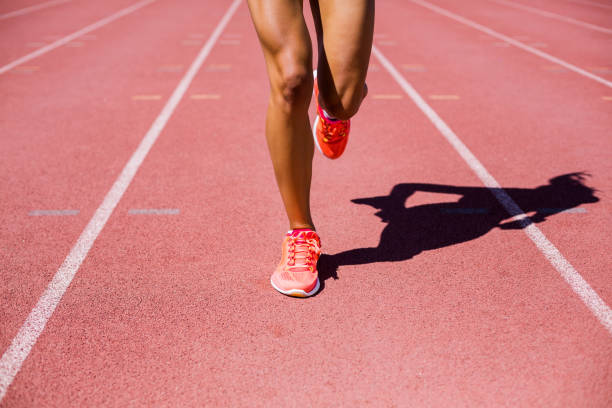 istock Female athlete running on the racing track 663894278