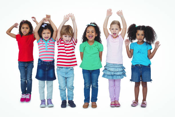 istock Small group of kids standing together with arms raised 663894710