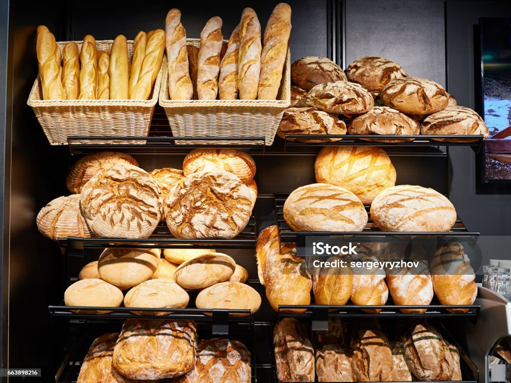 Fresh bread on shelves in bakery Fresh bread on shelves in a bakery Bakery Stock Photo