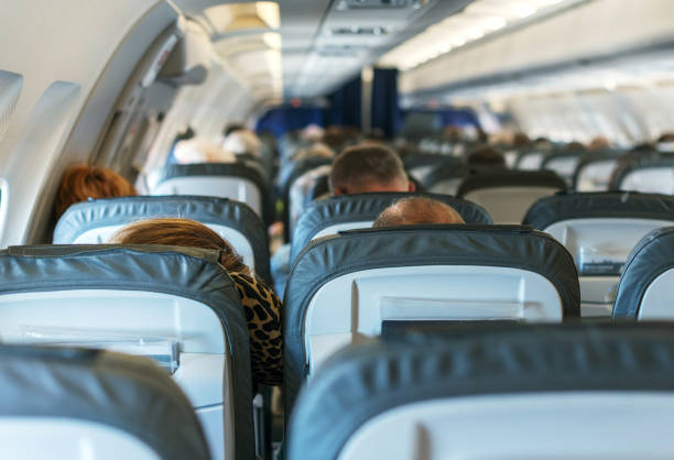 istock Interior inside of the plane with passengers. 663900996