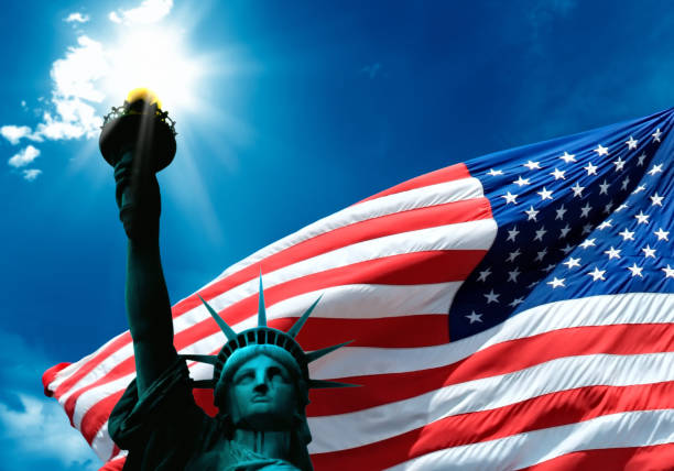 istock Statue of Liberty and American Flag 663902292