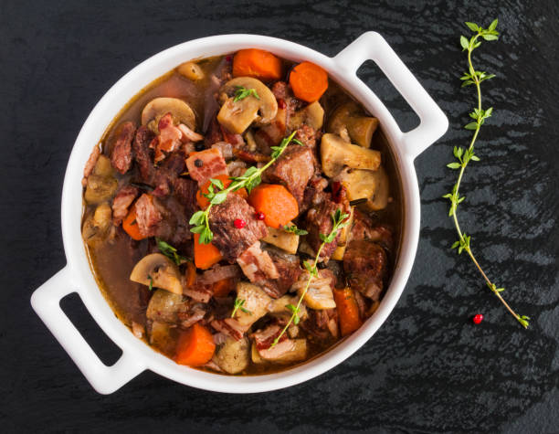 istock Beef Bourguignon in a casserole on black stone. 663905396