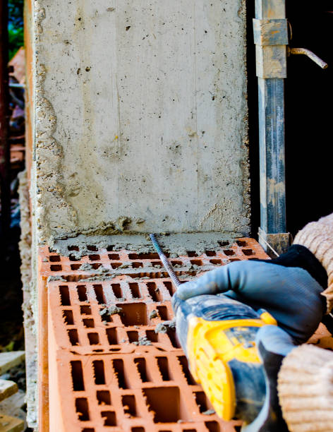 istock Seismic external masonry reinforcement operation in a building under construction 663905626