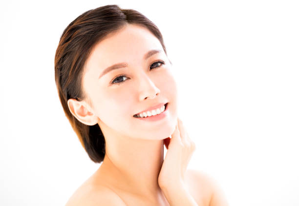 istock closeup   young  smiling woman face isolated on white 663905860
