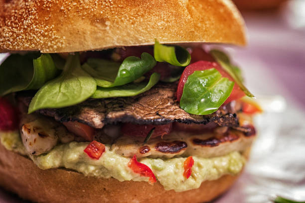 Delicious Portobello Mushroom Veggie Burger with avocado, tomato and fresh salad