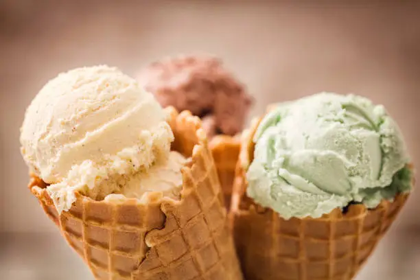 Homemade vanilla, chocolate and pistachio ice cream in a cone