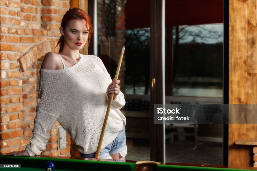 Attractive woman plays the game of snooker pool table Young attractive woman plays the game of snooker pool table 20-29 Years Stock Photo