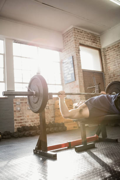 istock Cropped image of man holding barbell 663917590