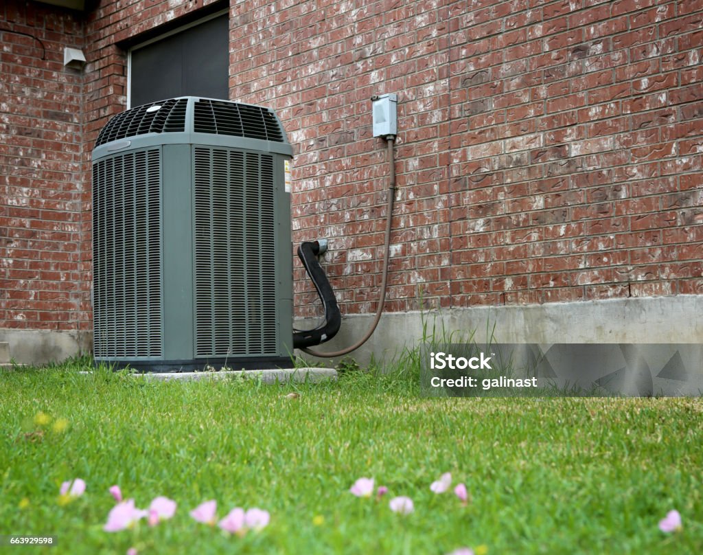 Modern AC High efficiency modern AC-heater unit on brick wall background Air Conditioner Stock Photo