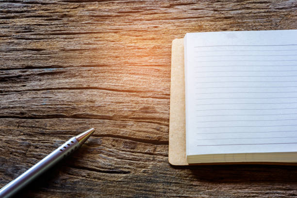 istock book and pen on wood table 663935932