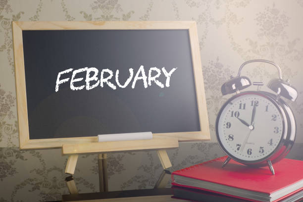 istock February on chalkboard with alarm clock. 663938034