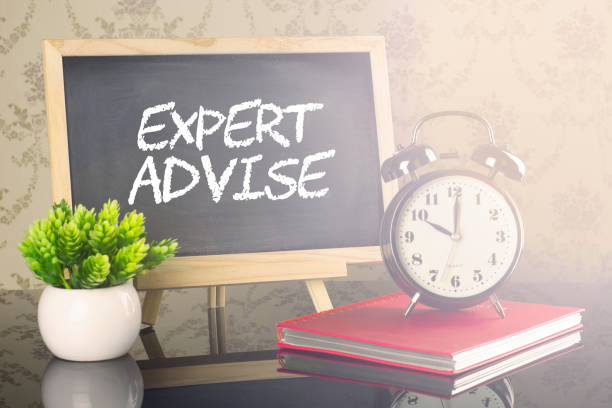 istock Expert Advise on blackboard with clock and flare 663941458
