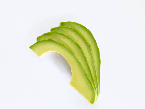fresh avocado sliceson white background