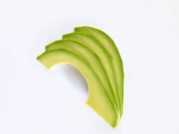свежие ломтики авокадо - avocado portion fruit isolated стоковые фото и изображения