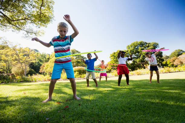 Kids playing hoop together during a sunny day