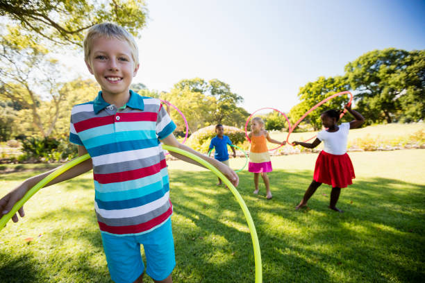 istock Kids playing hoop together during a sunny day 663948386