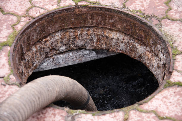 istock pumping sewage from the drain hole 663948484