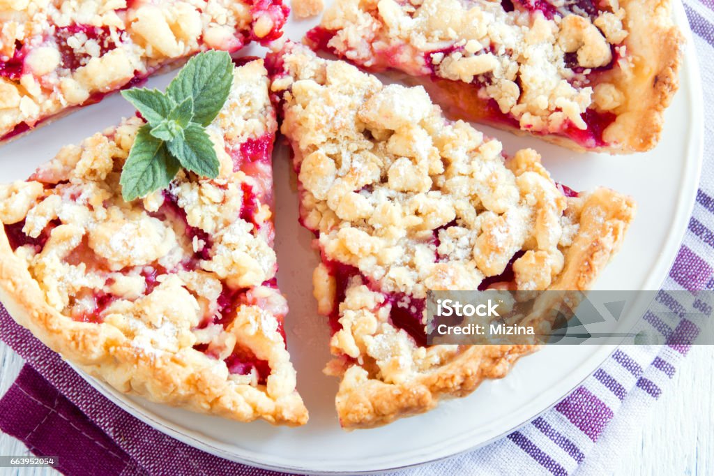 shortcrust fruit pie with crumble Homemade shortcrust fruit pie with crumble on white background - homemade pastry with fruit or berry (cherry, plum, strawberry, raspberry) jam for tea time American Culture Stock Photo