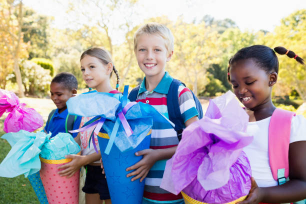 istock Kids posing with their gift surprise during a sunny day 663955498