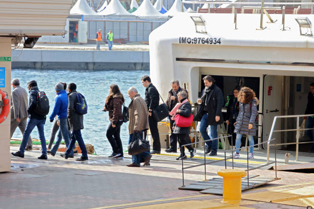 People disembark a scenic ferry in Kadikoy harbor in Istanbul, Turkey on March 23, 2017. Istanbul in Turkey's northwest is the only city on earth spanning two continents. The Bosphorus, a small stretch of water divides Europe from Asia. Istanbul's world famous ferries are one of the most popular ways to get around the city, it is estimated that more than 300,000 people take the ferry to work each day