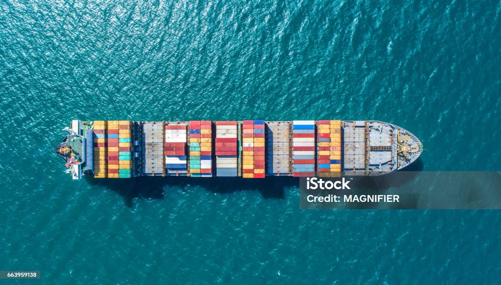 container ship in import export and business logistic.By crane ,Trade Port , Shipping.cargo to harbor.Aerial view.Water transport.International.Shell Marine.Top view. Container Ship Stock Photo