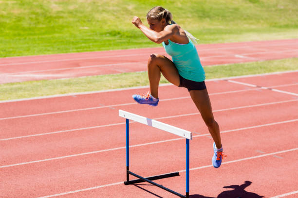 istock Female athlete jumping above the hurdle 663959934