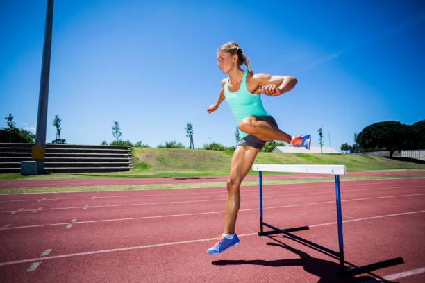 istock Female athlete jumping above the hurdle 663962410