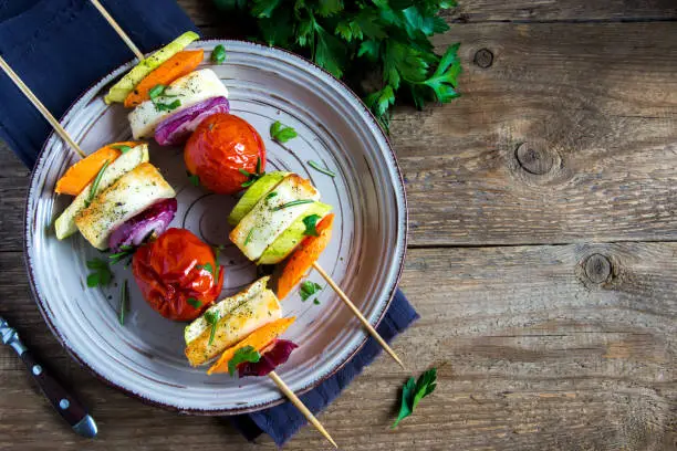 Halloumi cheese and vegetables grilled skewers on plate with spices and herbs close up - healthy vegetarian vegan diet barbecue grilled vegetable homemade meal