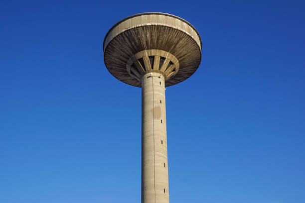 istock concrete two water towers against blue sky 663967306