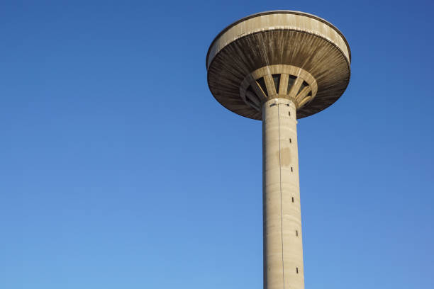 istock concrete two water towers against blue sky 663967396