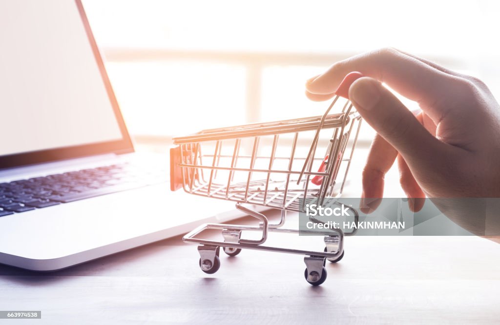 Online shopping concept with hand and cart Online shopping concept with woman hand and cart Ordering Stock Photo