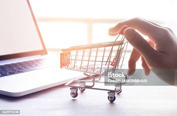 Online Shopping Concept With Hand And Cart Stock Photo - Download Image Now - Ordering, Shopping Cart, Online Shopping